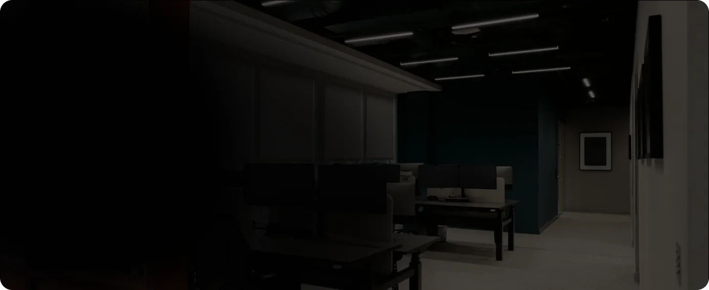 Company office with several desks containing screens on the background.