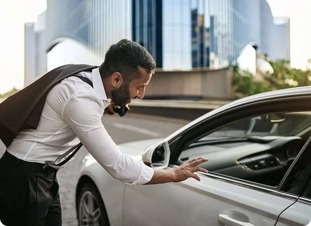 A man hails an uprides taxi.