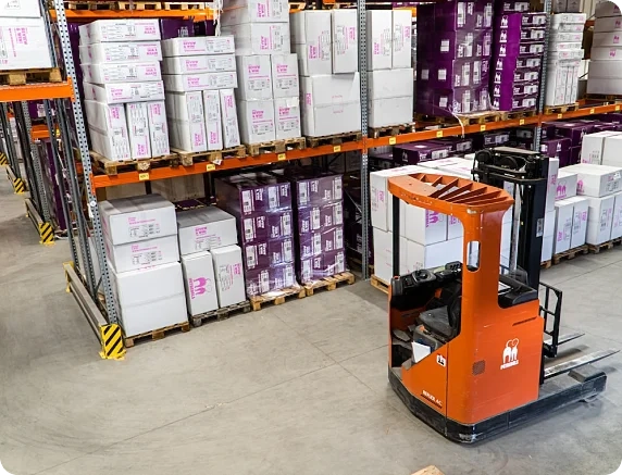 A large industrial crane efficiently moving and stacking packages for delivery.