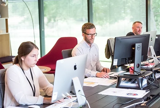 Employees working at their desk.